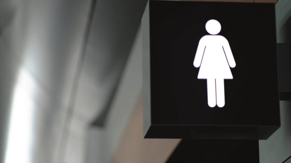 entrance to the male and female toilet. Sign in airport.